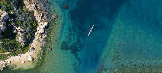 Aerial drone ultra wide photo of sport canoe cruising in tropical exotic Caribbean island sea