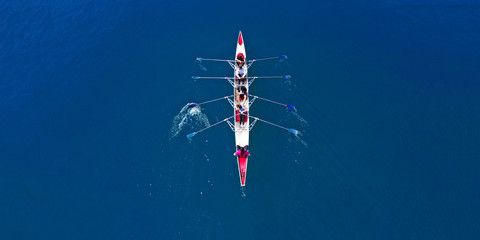 Aerial drone ultra wide photo of sport canoe with young team of athletes practising in deep blue...