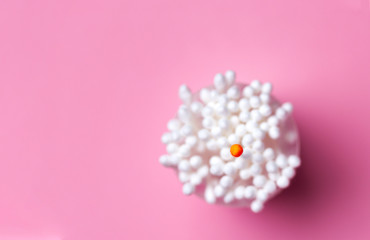 Bunch of cotton swabs in a bouquet with one swab red on top