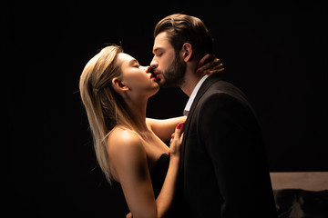 beautiful passionate couple going to kiss in dark room