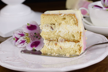 Delicious beautiful cake is impregnated with tender cream, decorated with flowers.