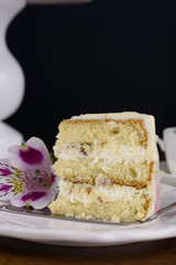 Delicious beautiful cake is impregnated with tender cream, decorated with flowers.
