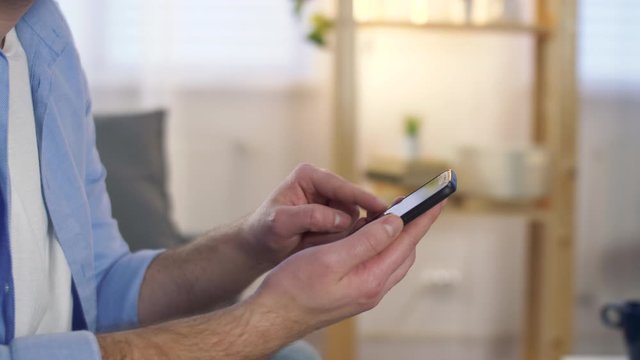 Close up of Man&rsquo;s Hands Holding Modern Smartphone. Businessman Typing on his Mobile Phone. Man in Modern Office Using Phone.