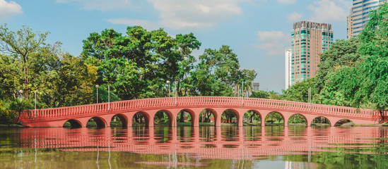 Bangkok, THAILAND - October 19 , 2019 :  Arch brick bridge over the lake at Jatujak(Chatuchak) public city park.