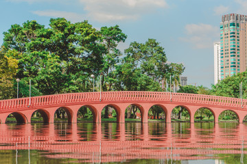 Bangkok, THAILAND - October 19 , 2019 :  Arch brick bridge over the lake at Jatujak(Chatuchak) public city park.