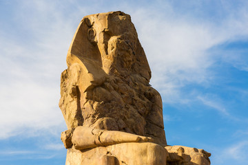 Colossi of Memnon Luxor Thebes against the background of dawn in the Egypt