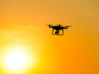 Quadrocopters silhouette against the background of the sunset