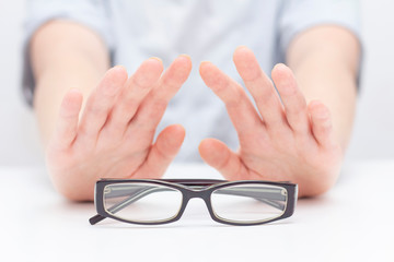 Refusal of glasses for sight. hands refuse glasses. cross on glasses. Vision improvement, laser vision correction.