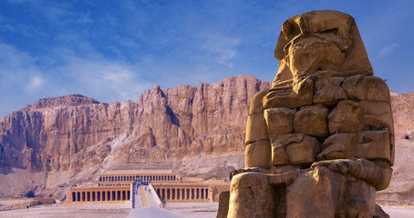Colossi of Memnon Luxor Thebes against the background of dawn in the Egypt