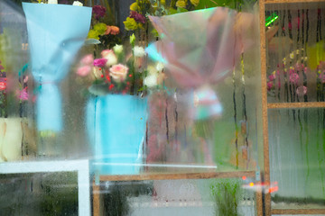 bouquets of flowers in a misted shop window