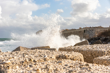  waves bouncing off the rocks in sicilia