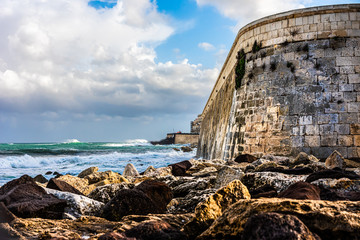 wall on coast of siracusa, italy