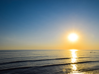 Sea sunset. People bathe in the evening at sunset in the sea.