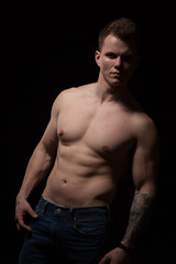 Fototapeta premium portrait of a beautiful fashionable strong man with a bare torso