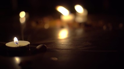 Candles burn at night and illuminate the darkness. They stand on the floor with a pentagram drawn in chalk. Witchcraft, Christianity, church. - Powered by Adobe