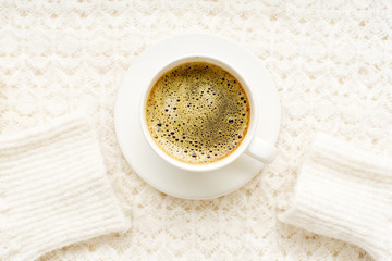 Flatlay with knitted sweater and a cup of coffee