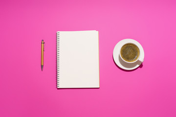  Flatlay with blank notepad, pen and coffee cup on pink background