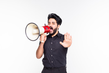 Portrait of young man handsome shouting using megaphone over white background