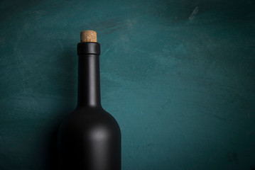 Wine tasting experience in the rustic cellar and wine bar: red wine glass and collection of excellent wines on the background