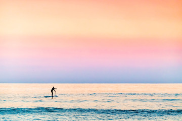 Paddler at dawn with pastel colours