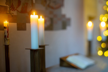 warmer, softer Kerzenschein und Lichterglanz im Altarraum einer Kirche mit Weihnachtsbaum