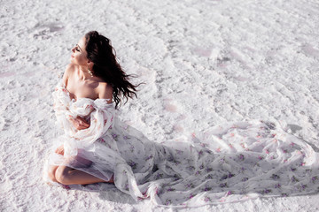 Beautiful woman on a pink lake.