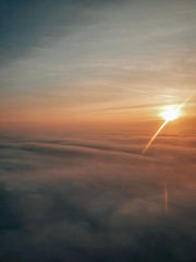 Obraz na płótnie Canvas sunset seen from an airplane porthole