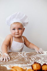 Little boy in a cook suit with buns