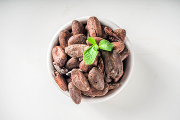 Cocoa beans on white background  top view copy space