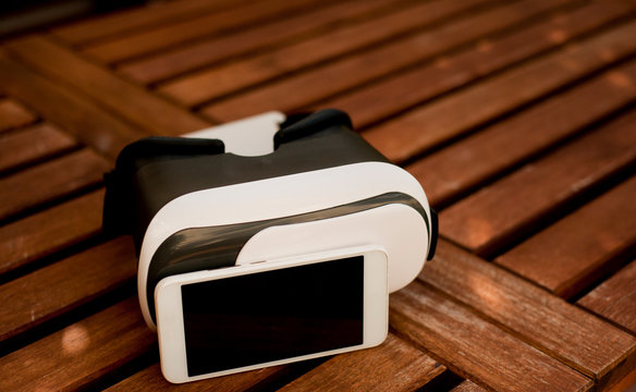 Virtual reality headset phone on wooden background