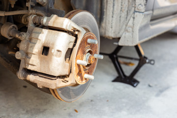 car disc brake during the wheel tire repair. Disc brake of the car during the maintenance at auto service garage.