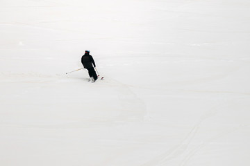 skier rolls down the mountain, top view