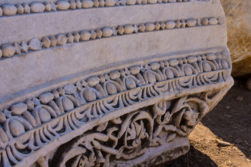 the base of an ancient marble column with a carved pattern
