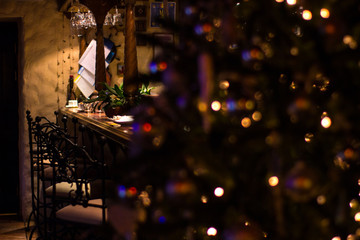 festive interior in the restaurant in dark and golden colors with elegant Christmas tree
