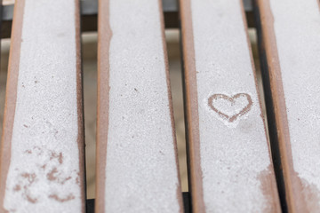 Heart in the snow. Bench. Winter.
