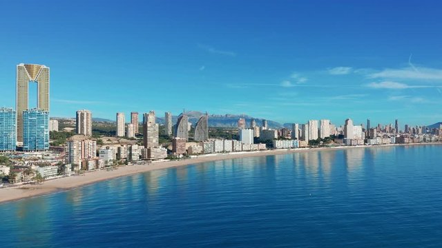 Benidorm - Mediterranean cityscape at sunrise. Spanish coast and high rise skyline of benidorm seaside resort. Aerial wide angle view at this summer holiday destination. 