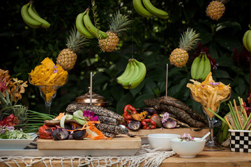 Fototapeta na wymiar Meat beautifully displayed surrounded with pineapples and bananas