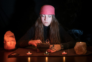 Caucasian witch mixing different herbs to make a spell or natural treatment