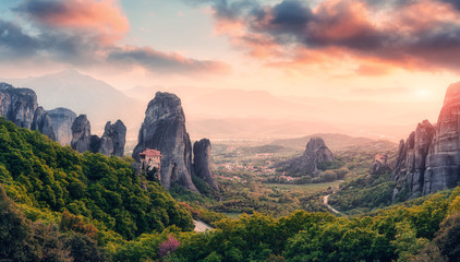 Wonderful Panoramic view of the rocks and monasteries of Meteora, Greece. Mysterious Sunny Morning with colorful sky, during sunrise. Awesome Nature Landscape. Amazing Greece. Popular travel location. © jenyateua