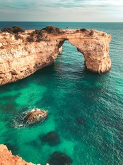 The famous cliffs and rocks in the ocean from a viewpoint over the ocean at sunset light. Perfect spot for travel ideas in europe. Farol da Ponta da Piedade, Lagos, Faro, Portimão, Algarve, Portugal