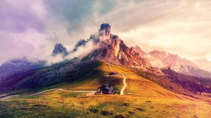 Awesome nature landscape. fantastic view of famous Dolomites mountain peaks glowing in beautiful golden morning light at sunrise in summer. Passo Giau, Dolomites, Italy. Majestic Dolomites Alps