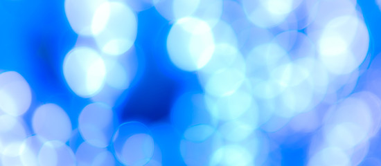 Fototapeta premium Abstract Bokeh Blue and green background of defocused glittering lights. Christmas, Party, New Year, luxurious background pattern concept. banner.