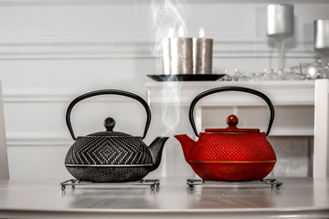 Woman hands with kettle and hot tea 