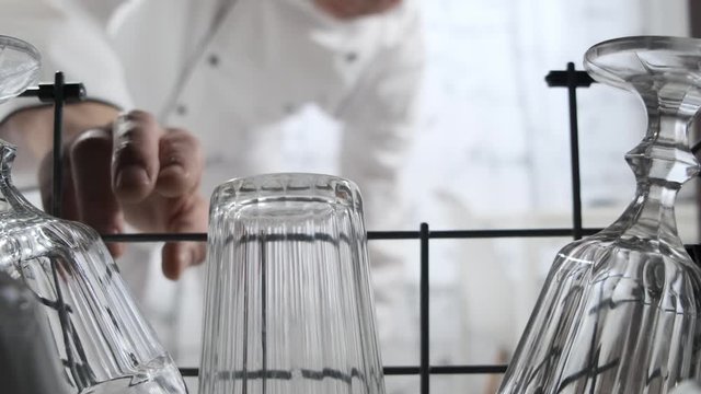 Glasses and plates, different dishes in the dishwasher. Close up.