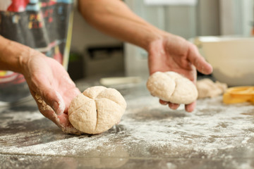 hands crumple dough, 