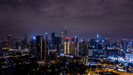 Fototapeta na wymiar Night view of Kuala Lumpur city skyline with illuminated Petronas twin towers