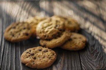 shortbread cookies with peanuts and chocolate on a wooden brown background. close-up.