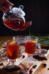 winter still life with fruit tea in tea pot, chocolate cookies on wooden background