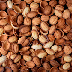 Walnut shaped cookies halves scattered on the oven tray. Food background