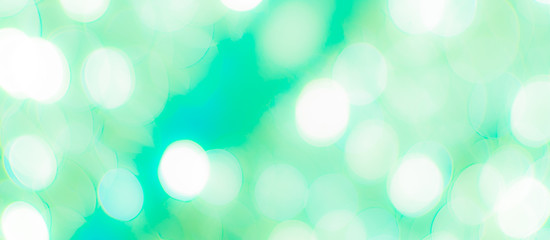 Abstract Bokeh Blue and green background of defocused glittering lights. Christmas, Party, New Year, luxurious background pattern concept. banner.